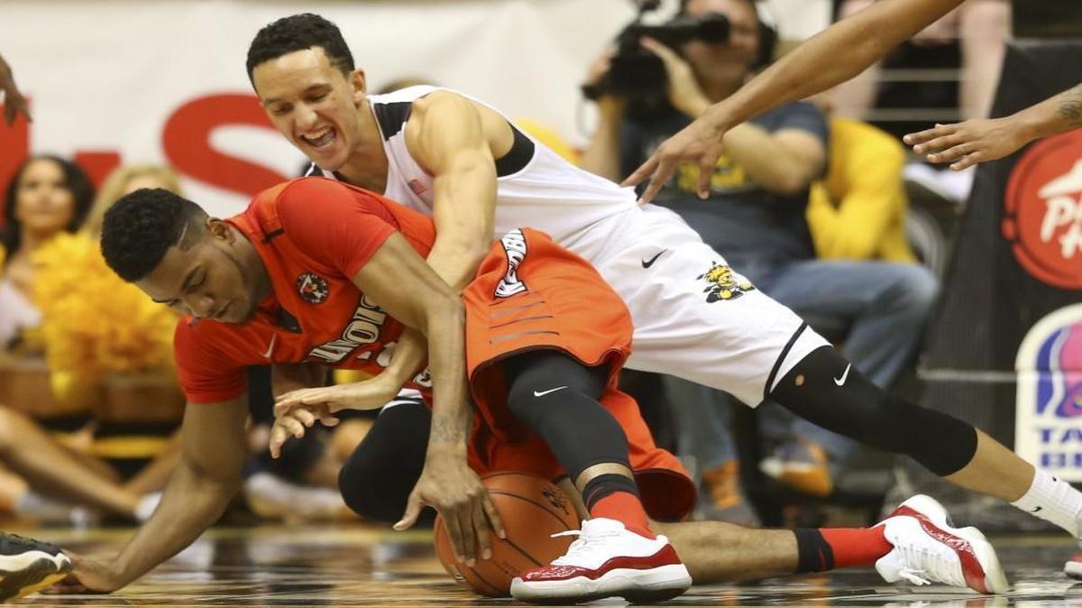 Wichita State guard Landry Shamet fights for a loose ball against Illinois State forward Phil Fayne during the first half of their game Saturday night at Koch Arena.
