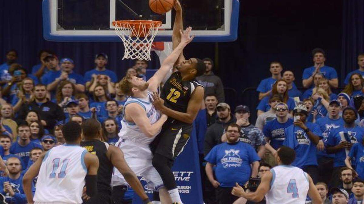 
Wichita State’s Darius Carter dunks a lob pass over Indiana State’s Jake Kitchell in the second half Wednesday in Terre Haute, Ind.
