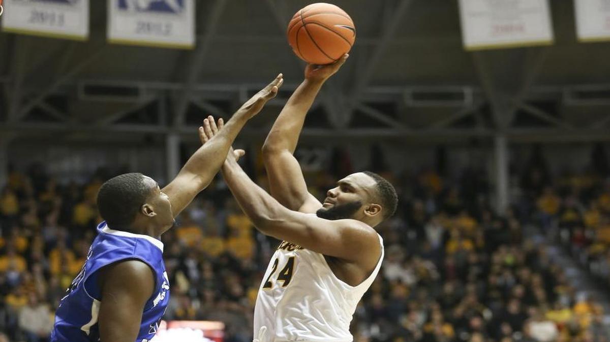 Wichita State junior Shaquille Morris shoots over Indiana State’s T.J. Bell during the first half Saturday at Koch Arena.