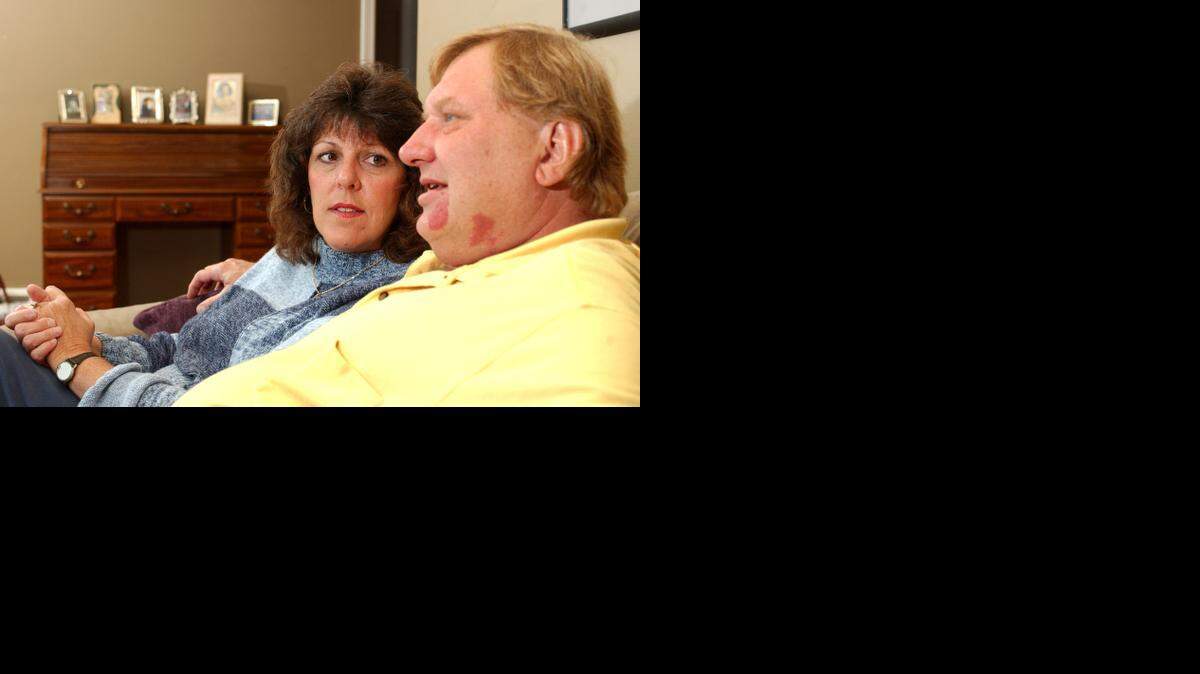 
Kathy Lewis listens to her husband, Dave, inside their Overland Park home. Dave Lewis was a survivor of the 1970 Wichita State plane crash that killed 31 people.
