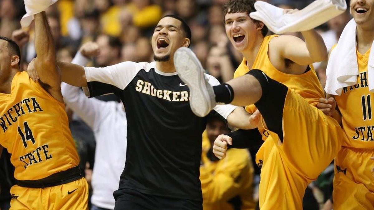 Wichita State’s Fred VanVleet, Evan Wessel and Landry Shamet cheer from the bench when Zach Bush scored a basket in the final minutes against Charleston Southern.