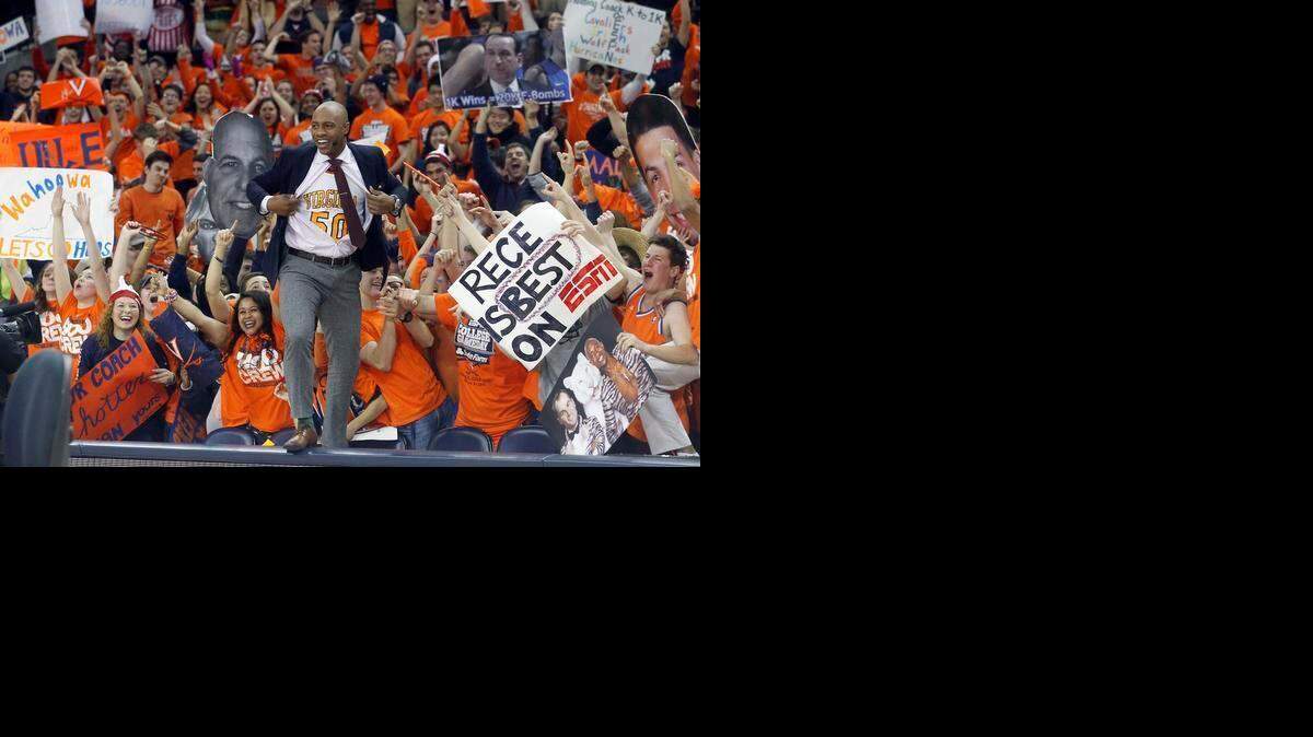 
ESPN’s Jay Williams shows off a Ralph Sampson jersey under his shirt during “GameDay” at the University of Virginia in January. Williams, Rece Davis, Jay Bilas, Seth Greenberg and Stephen A. Smith will be at Koch Arena on Saturday for Wichita State’s first time as the show’s host.
