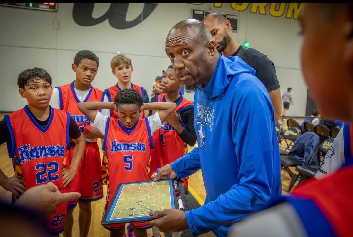 Tyrone Berry coaches Team PE 34, a Wichita-based AAU basketball team affiliated with Perry Ellis and River City Hoops, during a summer tournament game.