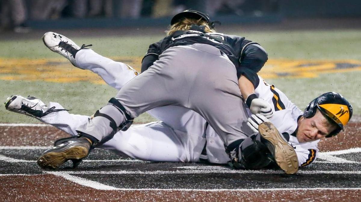 Wichita State's Chase Rader gets stopped at the plate by Cal Poly catcher Nick Meyer in the fourth inning Friday at Eck Stadium.