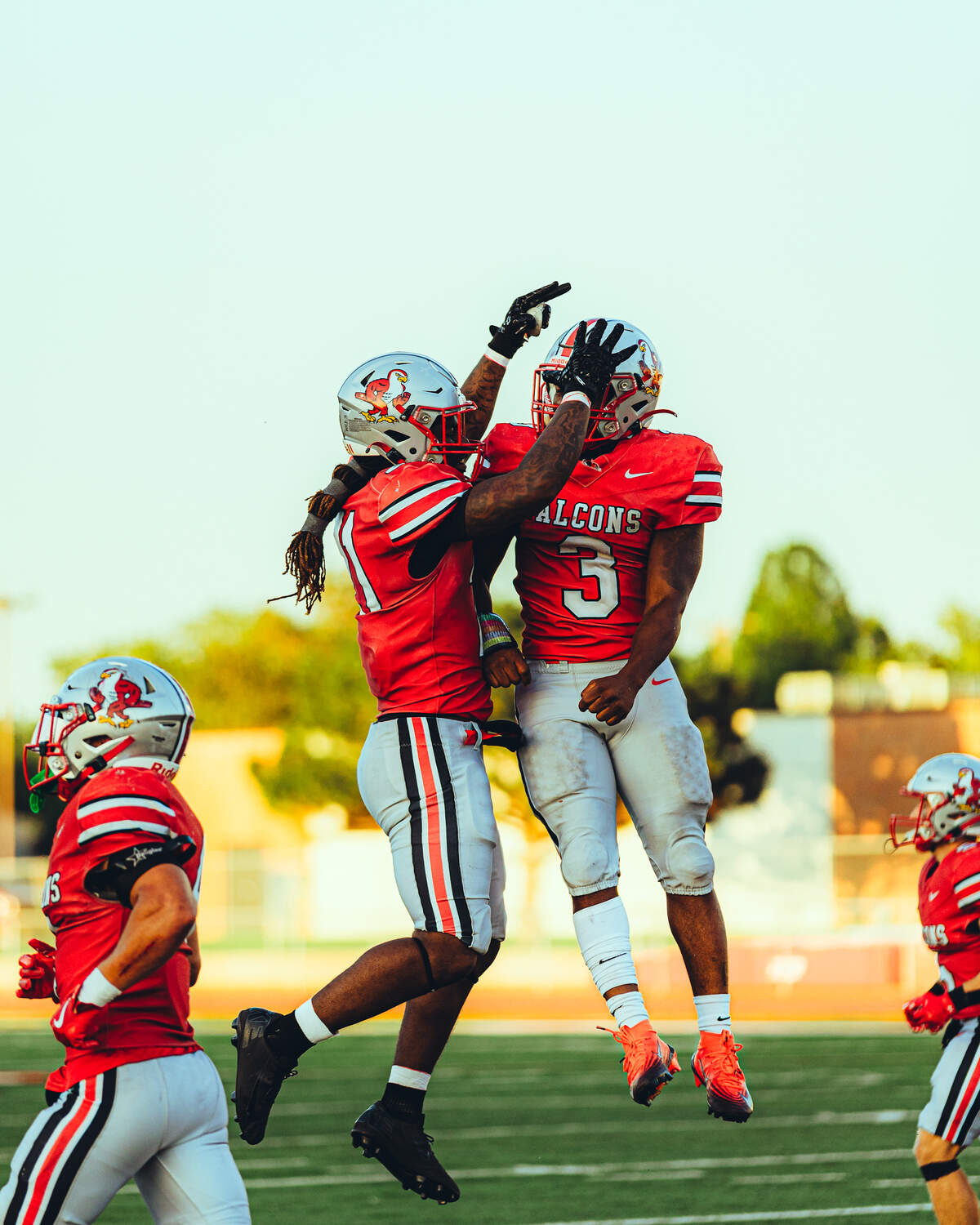 Friends quarterback K’Vonte Baker (right) celebrates after scoring on a long touchdown run in the flexbone offense.