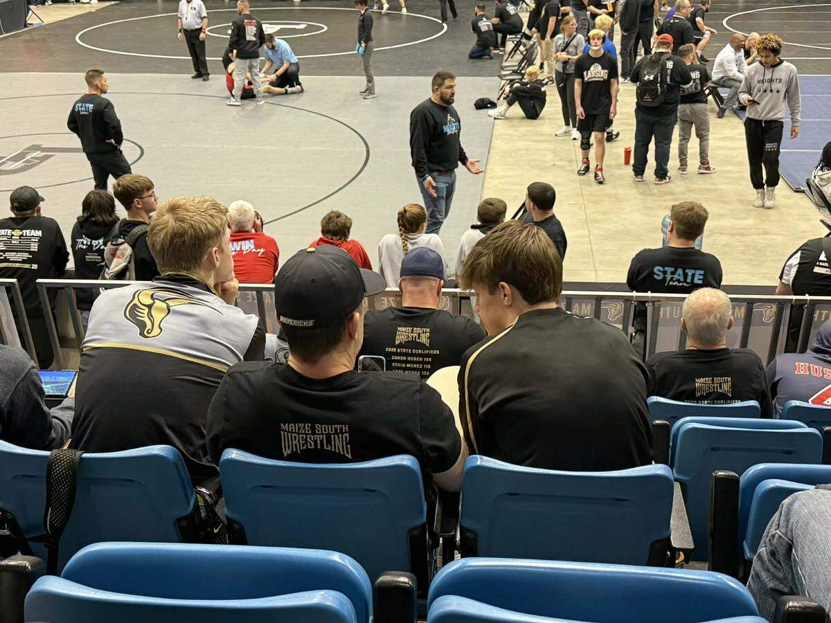 The Kerr brothers are fierce competitors with each other in the practice room, but each other’s biggest supporters on competition day. Josh (right) and Max (left) Kerr are both top-ranked wrestlers coached by their father, Matt (middle), at Maize South.