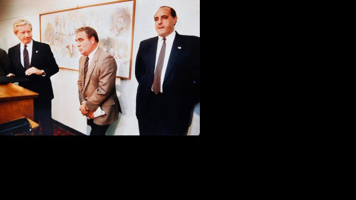 
President Warren Armstrong, left, gives the podium to football coach Ron Chismar, center, during a Dec. 2, 1986, news conference announcing the end of the Wichita State program. Athletic director Lew Perkins is at right.
