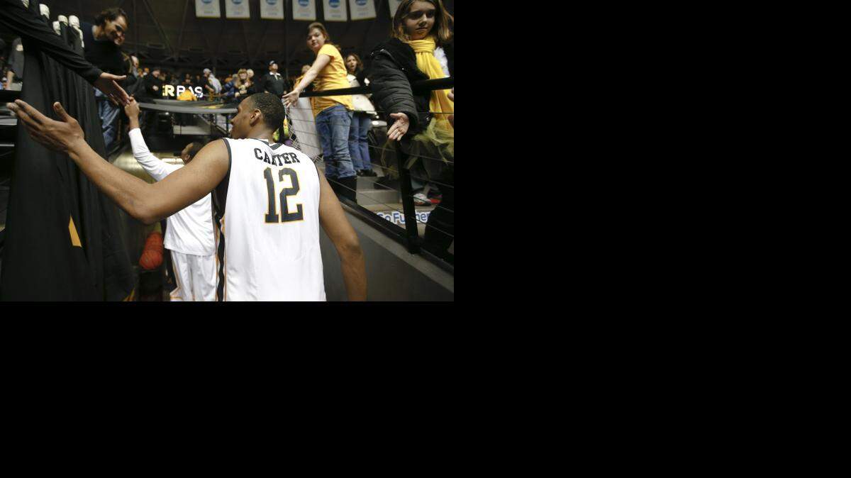 
Wichita State University's Darius Carter is congratulated by fans after a game in Dec. 2013.

