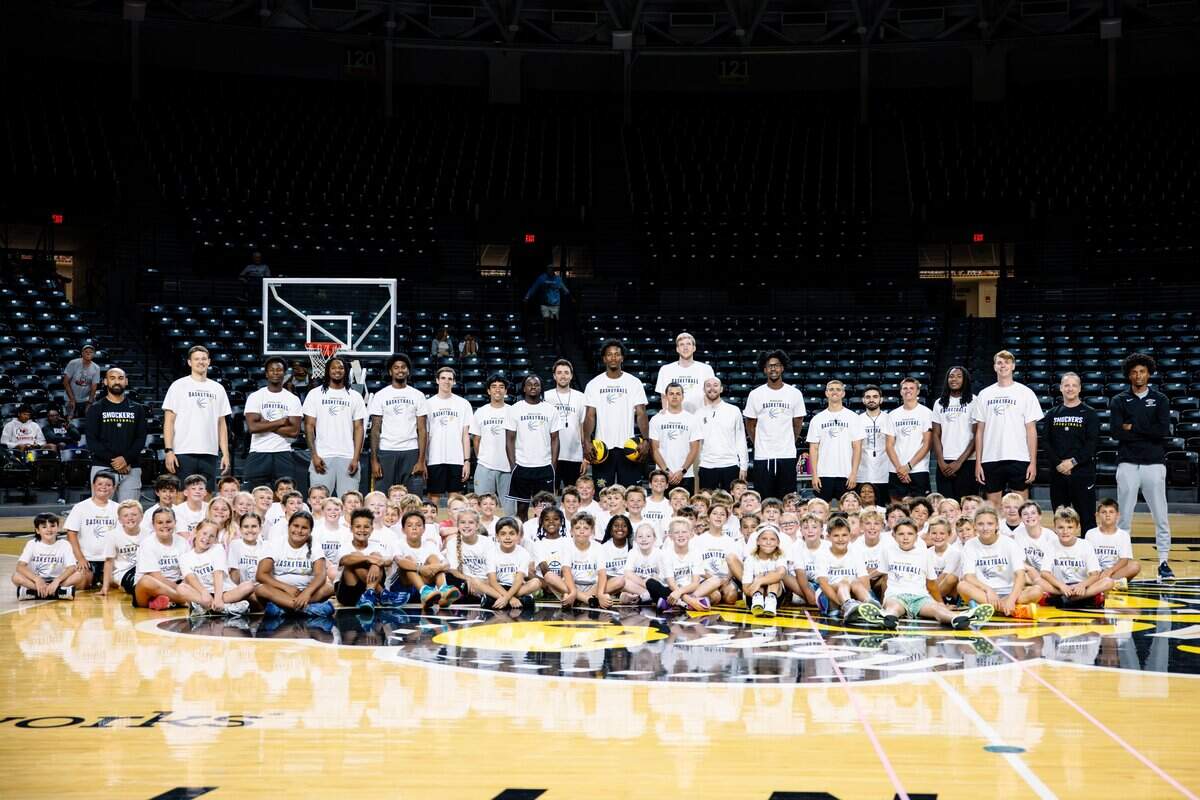 New Wichita State graduate assistant Connor Vanover, who stands 7-foot-5, towers above the group while posing for a photo at a recent Paul Mills basketball camp.
