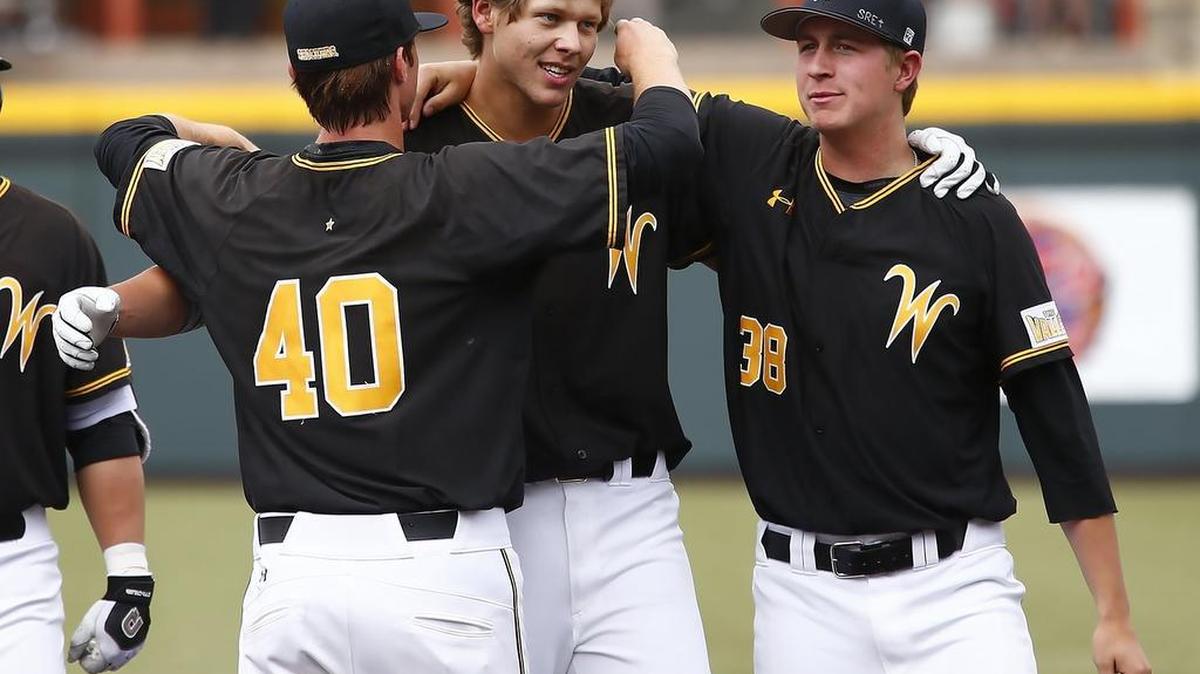 Wichita State's Alec Bohm, middle, is congratulated by teammates Clayton McGinness, left, and Robby Evans after delivering a 10-9 game-winning single to center in the 10th inning Sunday against Bradley.