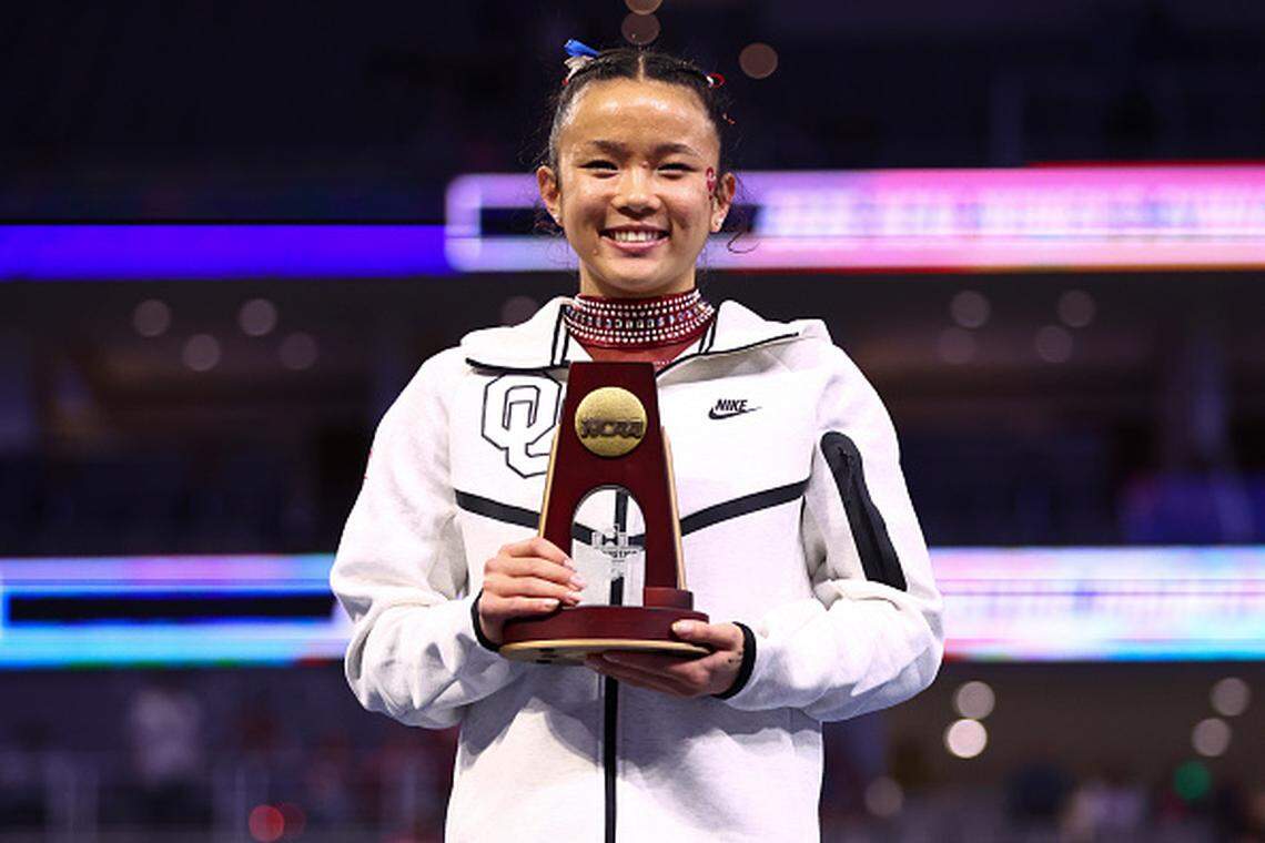 Augusta native Keira Wells poses with the championship trophy after finishing first in vault during the National Collegiate Women's Gymnastics Championship in Fort Worth.