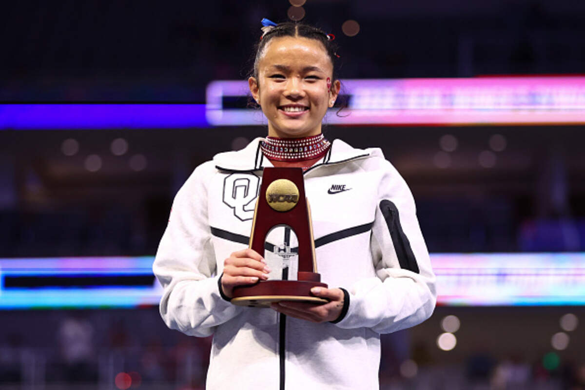 Augusta native Keira Wells poses with the championship trophy after finishing first in vault during the National Collegiate Women's Gymnastics Championship in Fort Worth.