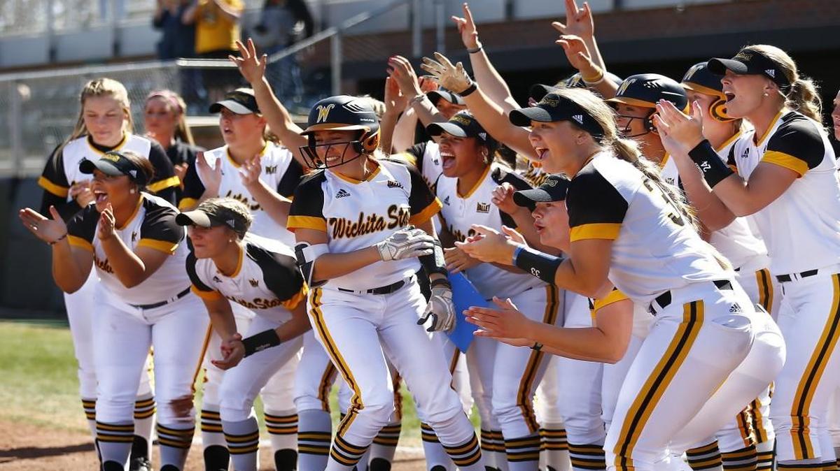 The Wichita State Shockers gather at the plate to welcome baserunners ahead of Laurie Derrico, who hit a grand slam against Drake in the fourth inning of Saturday’s first game.