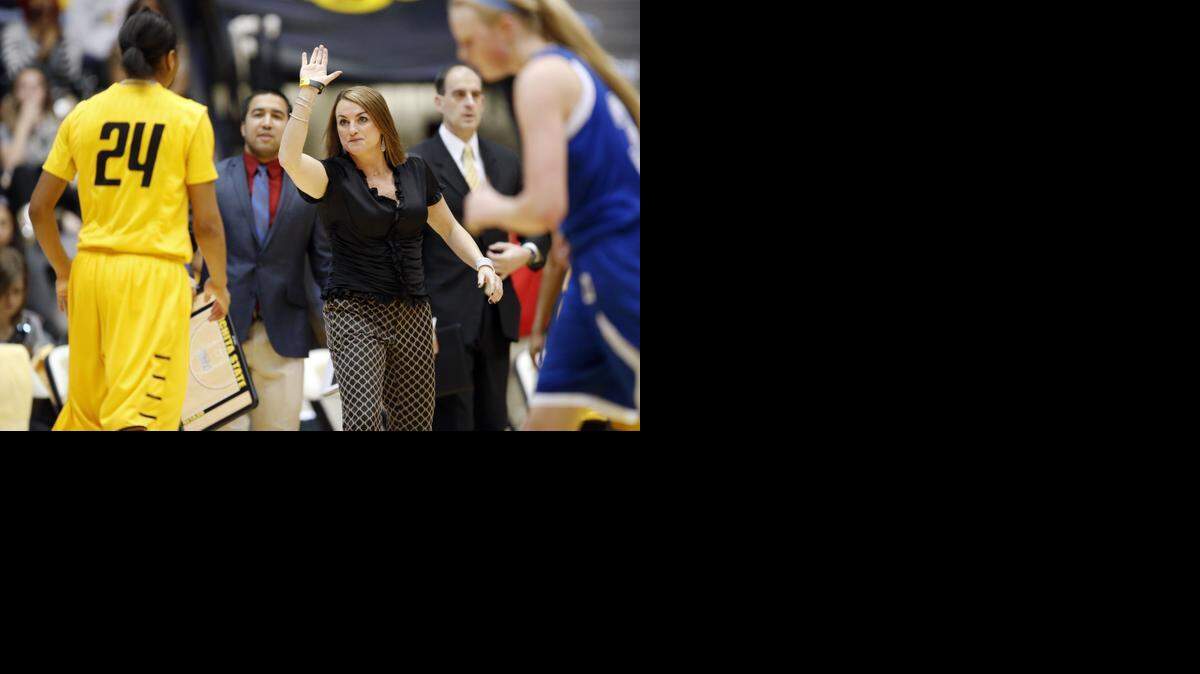 
Wichita State coach Jody Adams congratulates Alex Harden after she hit a three-point goal against Drake last season.
