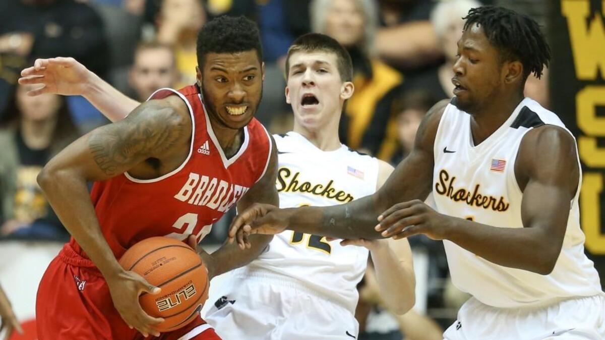 WSU guard Austin Reaves, center, has taken three charges this season. As a team, the Shockers have 14 charges through nine games.