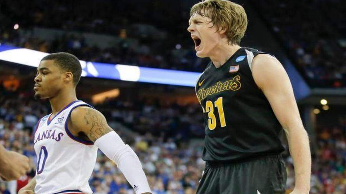
Wichita State guard Ron Baker screams in celebration after teammate Darius Carter hit a shot and was fouled during the second half against Kansas.
