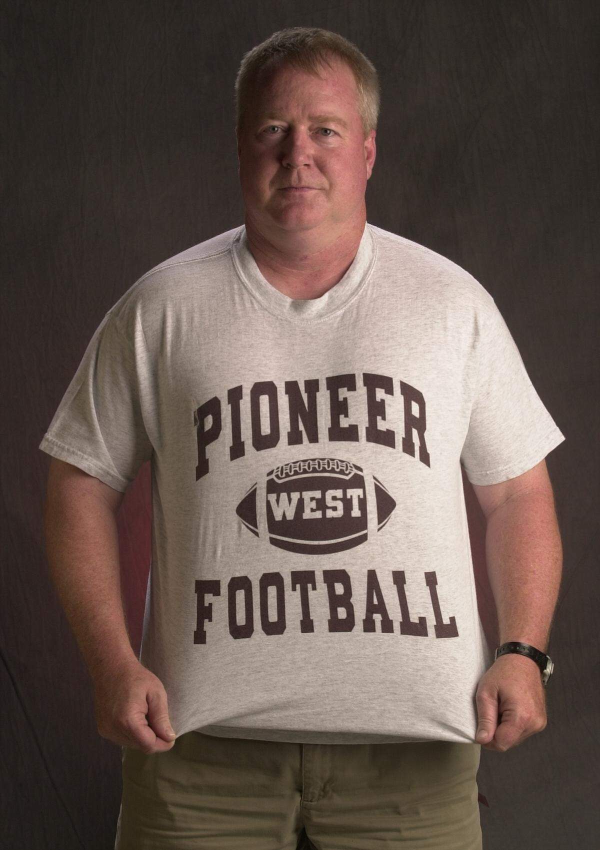 Weston Schartz shows off his West High football shirt during his first stint as head coach there.