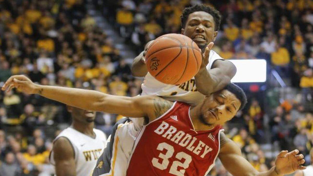 
Wichita State freshman Zach Brown fights for a rebound against Bradley forward Mike Shaw during the first half Wednesday night at Koch Arena.
