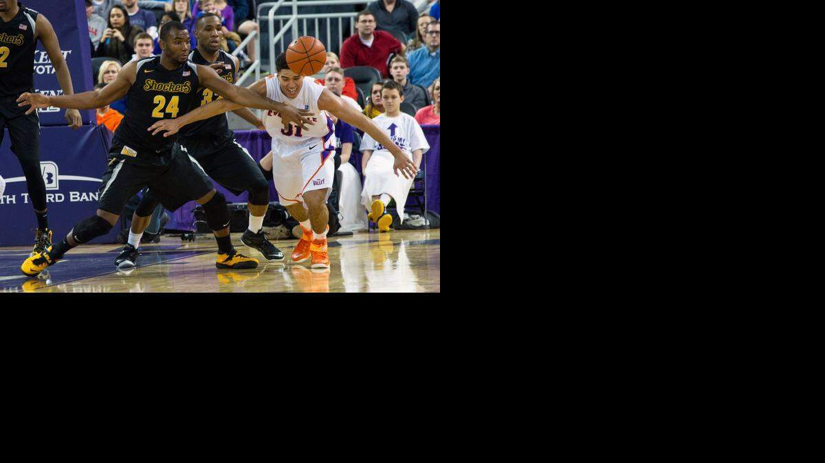 
Wichita State’s Shaquille Morris (24) and Tekele Cotton (32) go for a loose ball against Evansville’s D.J. Balentine (31) in the second half of an NCAA college basketball game Saturday, Jan. 17, 2015, in Evansville, Ind. Wichita State won 61-41. (AP Photo/Daniel R. Patmore) 
