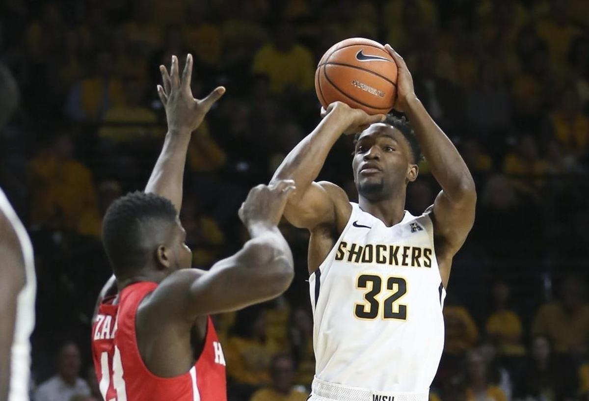 Wichita State forward Markis McDuffie shoots a three-pointer over Houston forward Cedrick Alley Jr. during the first half of their game at Koch Arena on Jan. 4.