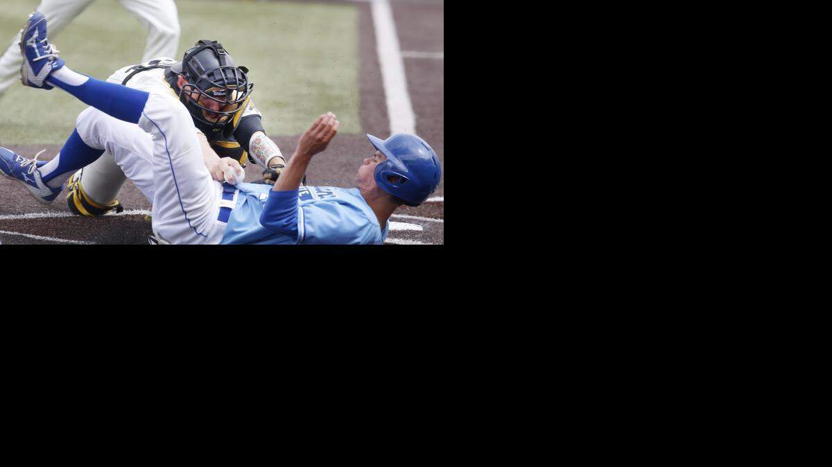 
Wichita State University catcher Bob Arens tags out Indiana State's Landon Curry in the third inning on Sunday at Eck Stadium. 
