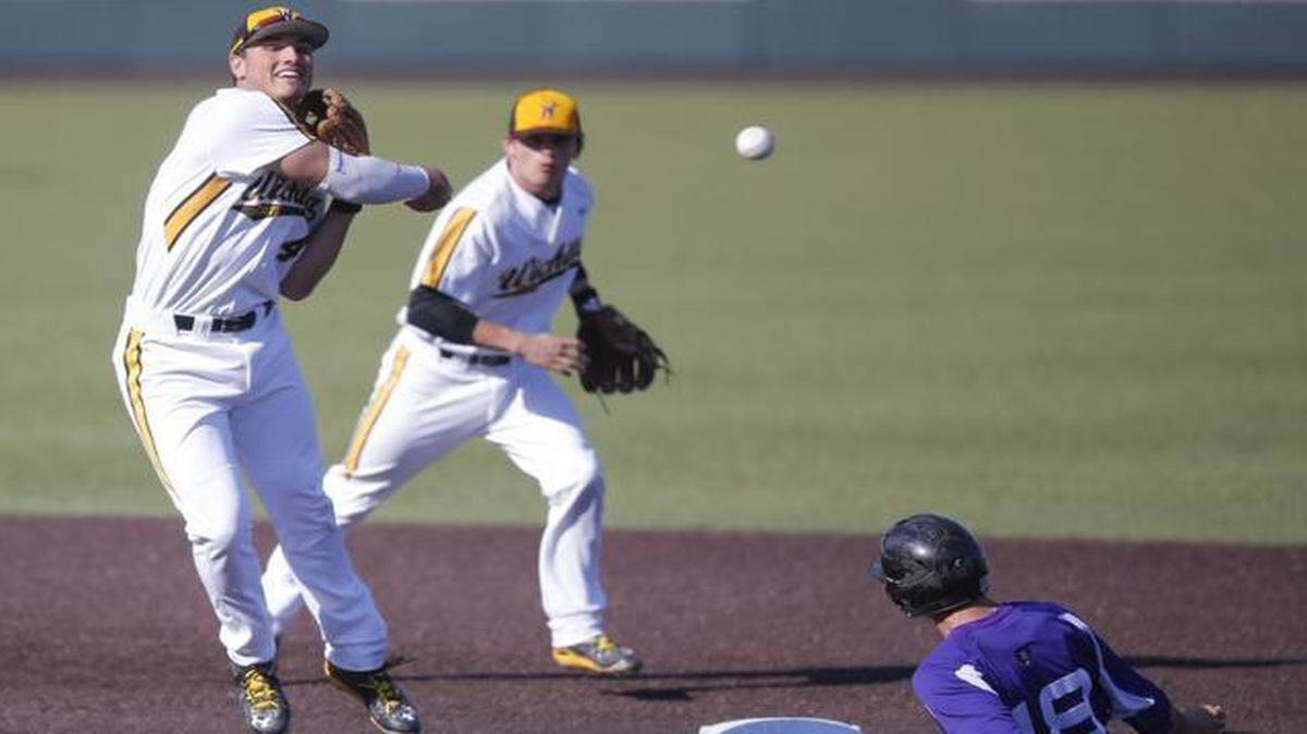 
Wichita State's Jordan Farris tries to complete a double play while Central Arkansas' Nate Ferrell slides into second Tuesday at Eck Stadium.
