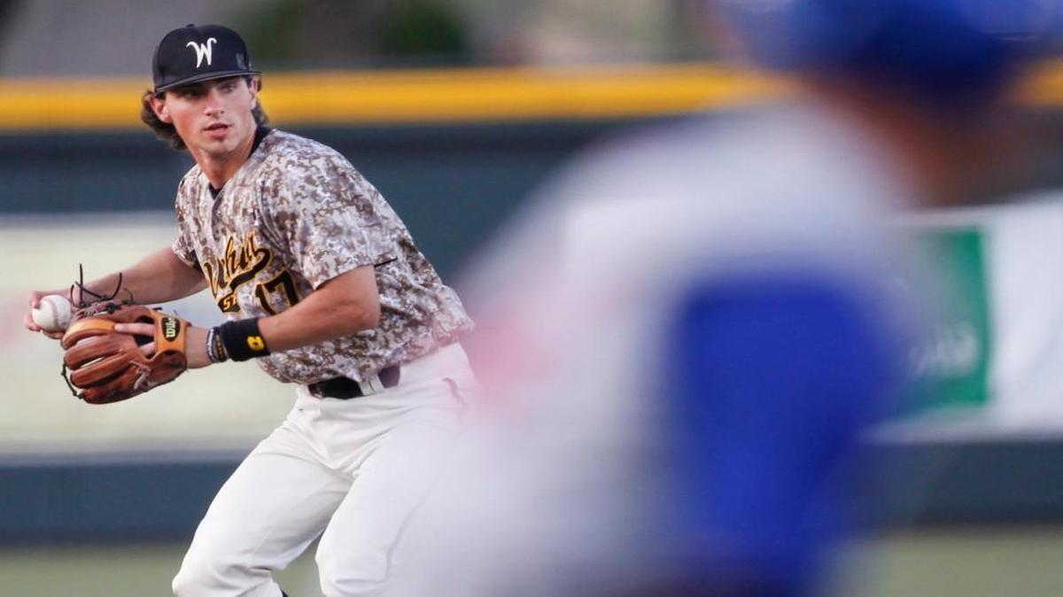 Wichita State shortstop Trey Vickers throws out a Kansas runner last season at Eck Stadium.