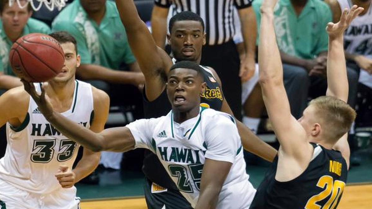 
Hawaii forward Mike Thomas splits Wichita State freshmen Rashard Kelly, top, and Rauno Nurger during Tuesday’s game in Honolulu. The Shockers won the game in overtime with contributions from several freshmen. 
