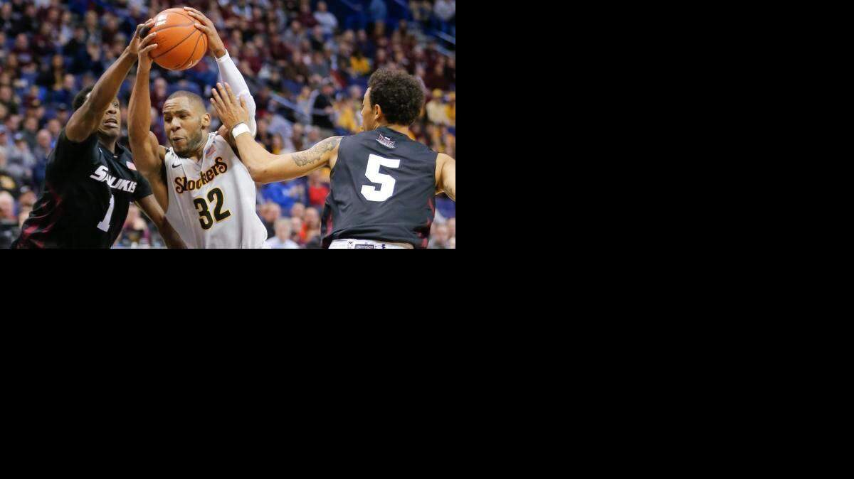 
Wichita State guard Tekele Cotton drives to the basket against Southern Illinois forward Jalen Pendleton. Cotton became the Shockers’ 44th 1,000-point scorer.
