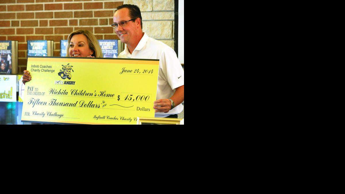 
Wichita State University men's basketball Coach Gregg Marshall presents Wichita Children's Home with a check for $15,000 from the Infiniti Coaches Charity Challenge in June, 2014. At left is Janet Pack, director of development at the Wichita Children's Home at the time. 
