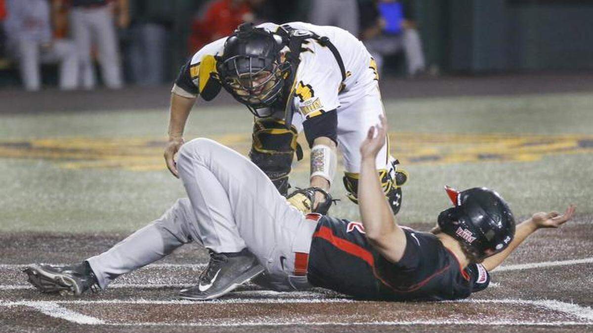 
Illinois State's Daniel Dwyer slides safely home under the tag of Wichita State catcher Bob Arens in the seventh inning to give the Redbirds a 7-2 lead Friday at Eck Stadium.
