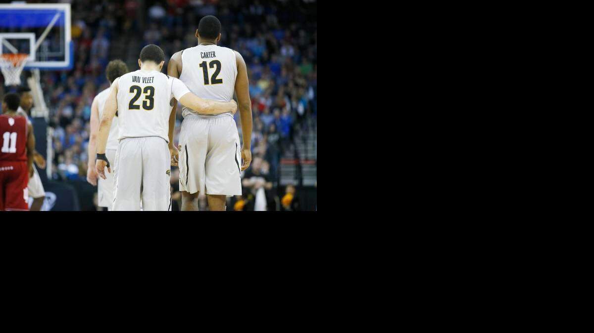 
Wichita State guard Fred VanVleet puts his arm around Wichita State forward Darius Carter in the final moments of their NCAA Tournament game against Indiana at CenturyLink Center in Omaha. (March 19, 2015)
