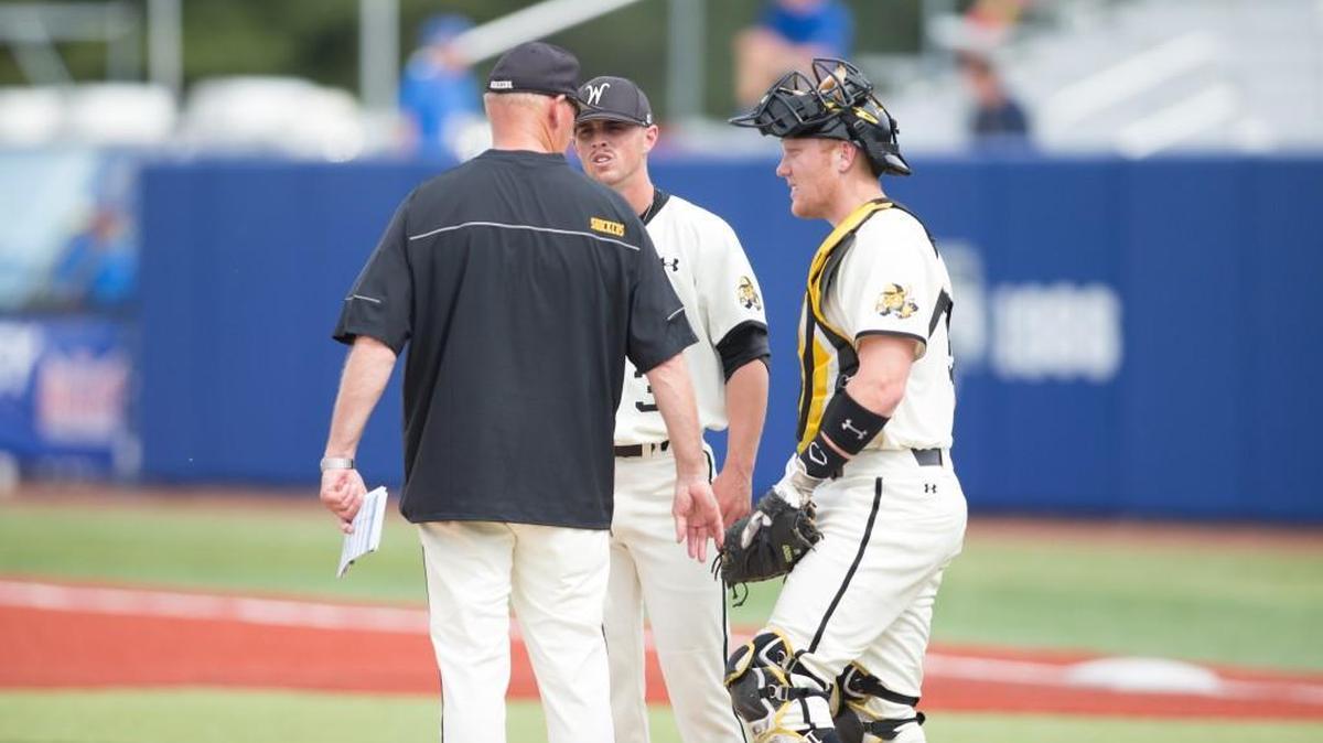 WSU pitching coach Brent Kemnitz, left, talks with catcher Gunnar Troutwine during Thursday’s elimination loss to Indiana State.