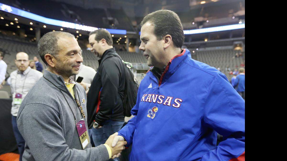 
Wichita State athletic director Eric Sexton, left, talks with Kansas AD Sheahon Zenger during the NCAA Tournament in Omaha in March.
