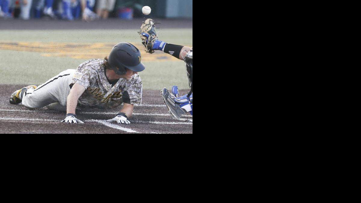 
Wichita State’s Trey Vickers slides into home under the throw in the third inning against Kansas on Wednesday night at Eck Stadium.
