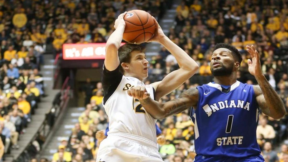 Wichita State guard Austin Reaves goes to the basket against Indiana State guard Demonte Ojinnaka during the first half Saturday at Koch Arena.