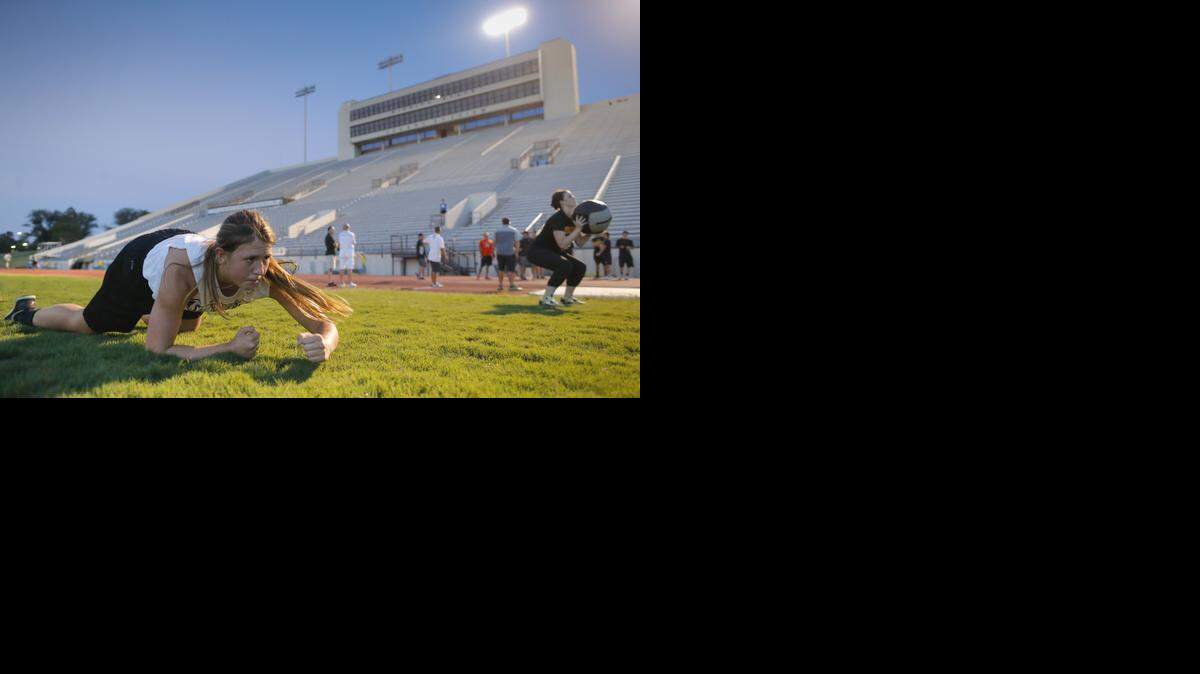 
Moriah Dapprich crawls on the turf of Cessna Stadium during a women's basketball boot camp on Friday. The team is getting ready for a tough non-conference schedule with boot camp workouts.
