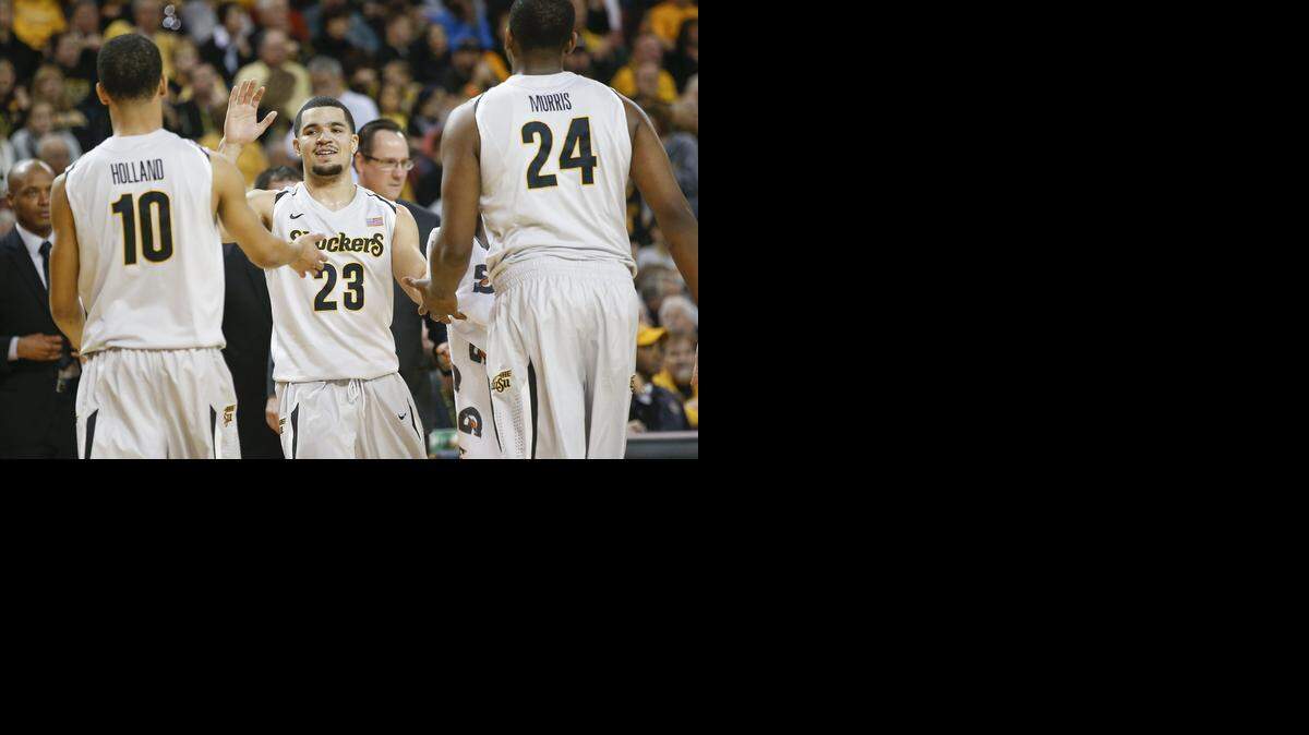 
WSU's Fred Van Vleet (23) congratulates Ria'n Holland (10) and Shaquille Morris (24) after a good run against St Louis in the first half at Intrust Bank Arena Saturday (Dec. 6, 2014) 
