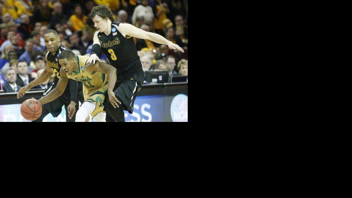 
Notre Dame guard Demetrius Jackson sneaks by Wichita State’s Tekele Cotton and Evan Wessel in the Midwest Regional semifinal of the NCAA Tournament at QuickenLoans Arena in Cleveland.
