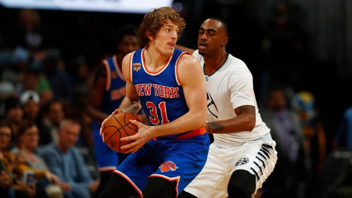 New York Knicks guard Ron Baker (31) and Denver Nuggets forward Darrell Arthur (00) in the second half of an NBA basketball game Saturday, Dec. 17, 2016, in Denver.