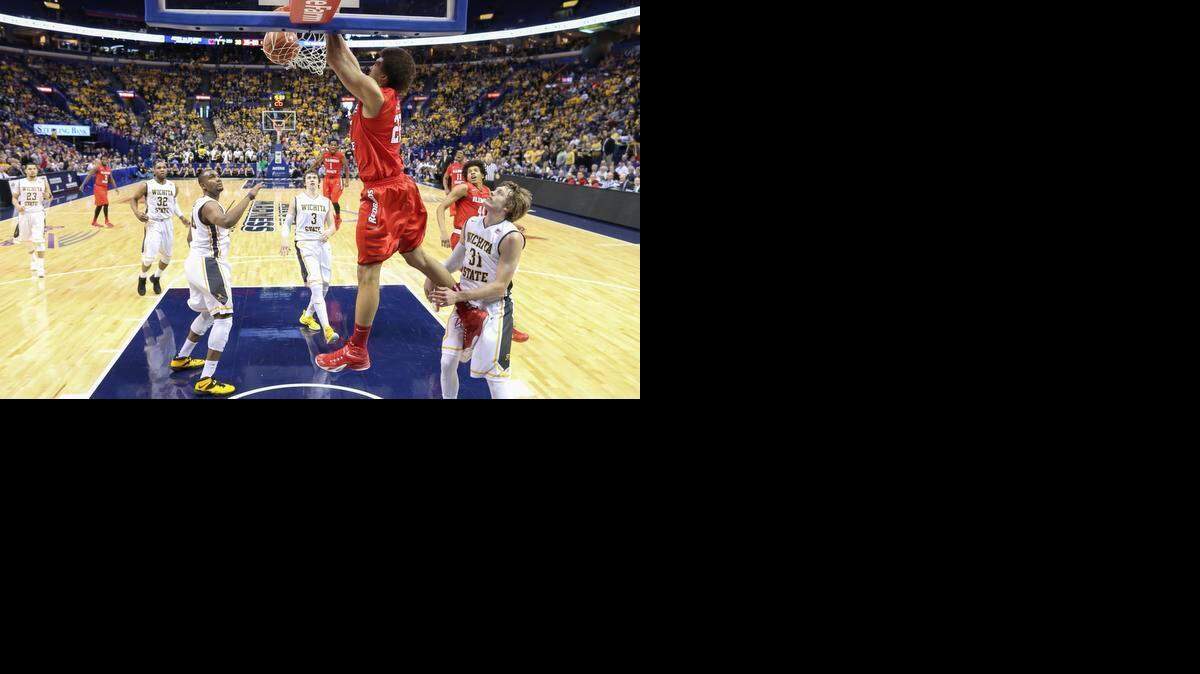 
Illinois State center Reggie Lynch dunks over Wichita State forward Shaq Morris during the second half of their semifinal game at the Scottrade Center in St. Louis on Saturday.
