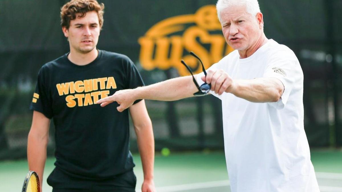 WSU tennis coach Brad Louderback, right, works with Sergio de Vilchez in April.