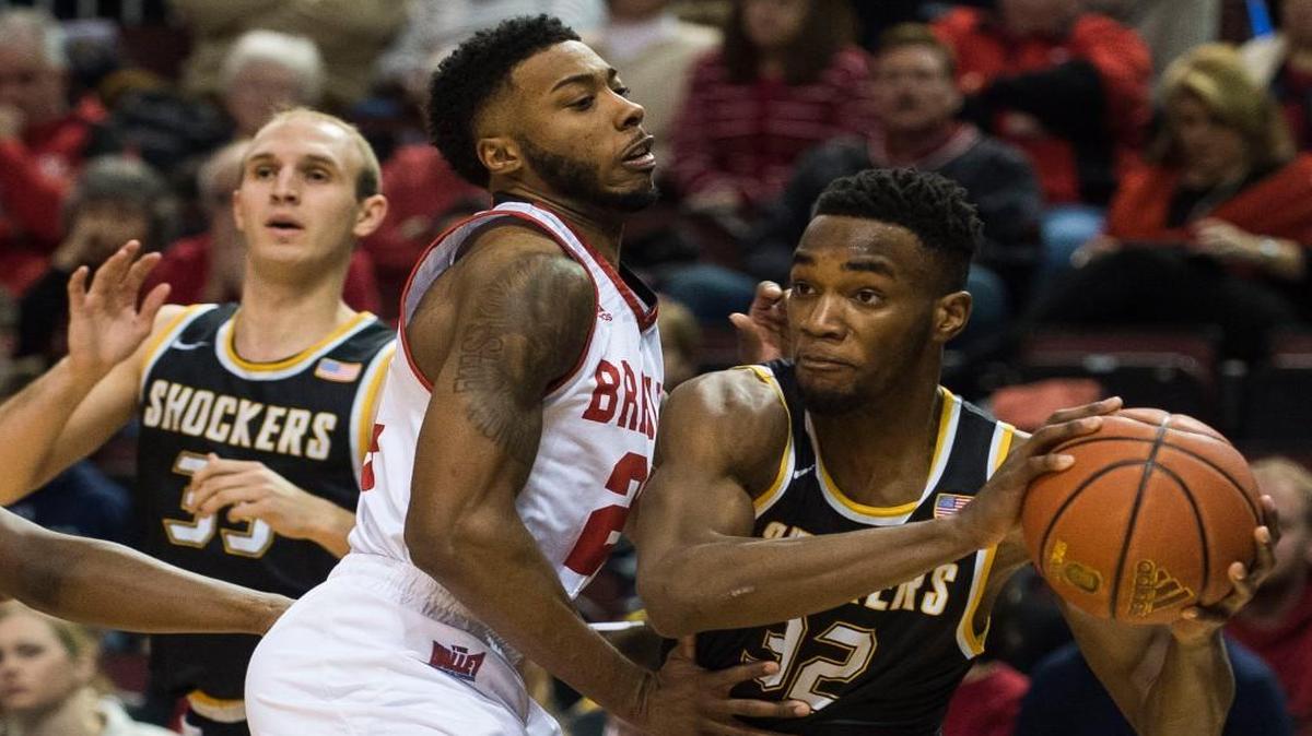 Wichita State forward Markis McDuffle (32) looks to make a pass around Bradley junior JoJo McGlaston on Sunday.