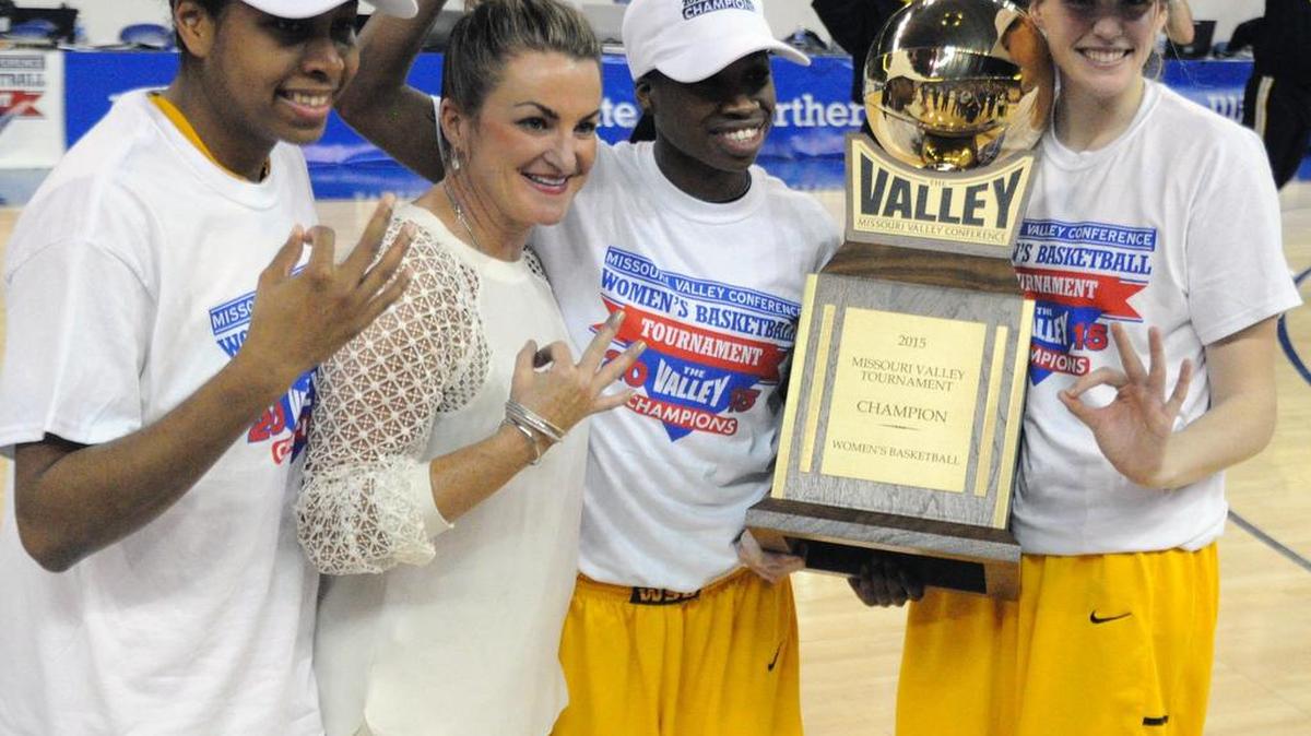 
Wichita State’s Alex Harden, coach Jody Adams, Jamillah Bonner and Kesley Jacobs receive the MVC tournament trophy in March.
