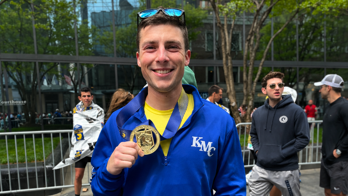 Father Seth Arnold, a Wichita native and Kapaun Mt. Carmel chaplain, holds his medal after running the Boston Marathon in 2 hours, 35 minutes, 45 seconds.