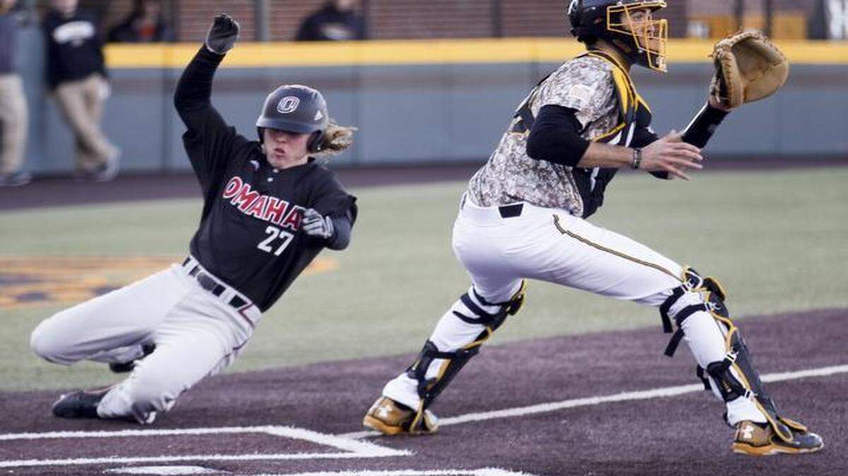 
Wichita State catcher Ryan Tinkham waits for the throw as Nebraska-Omaha’s Ryan Cate scores in the fourth inning Tuesday at Eck Stadium.
