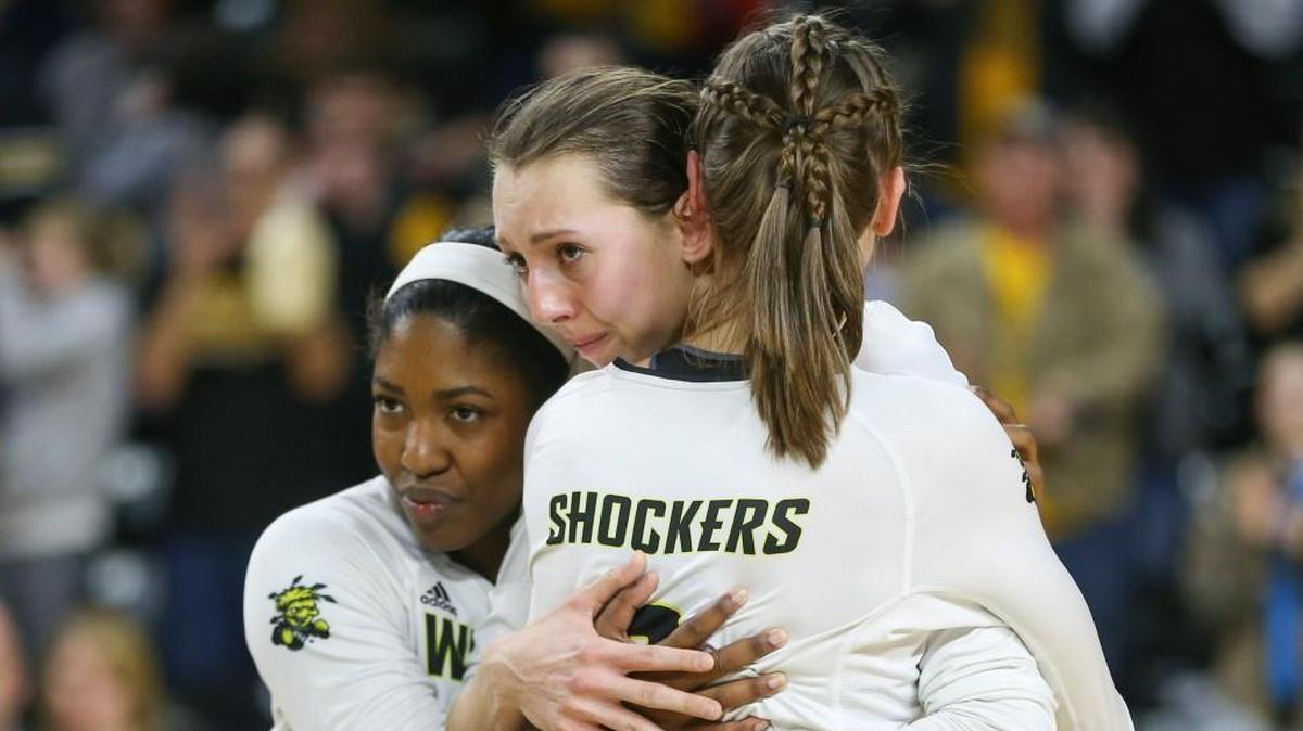 Three Wichita State volleyball players, Abbie Lehman, middle, Tabitha Brown, left, and Mikaela Raudsepp embrace on the court after Missouri ended their season with a four-set win in the second round of the NCAA Tournament on Saturday at Koch Arena.