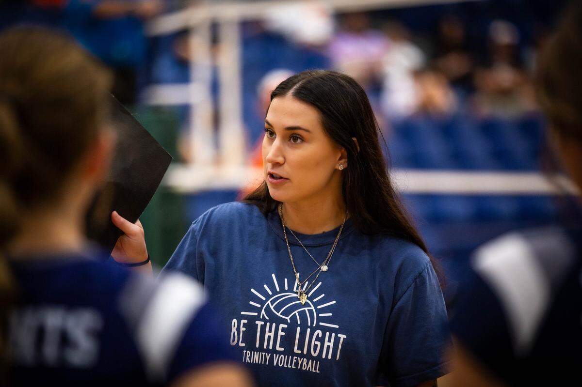 Wichita Trinity volleyball coach Katelyn Moore-Turner, 24, has helped guide her players — and herself — through unimaginable grief after losing her mother and younger sister in a 2023 car crash. Together, they’ve turned pain into purpose during the Knights’ run to the Class 3A state semifinals.