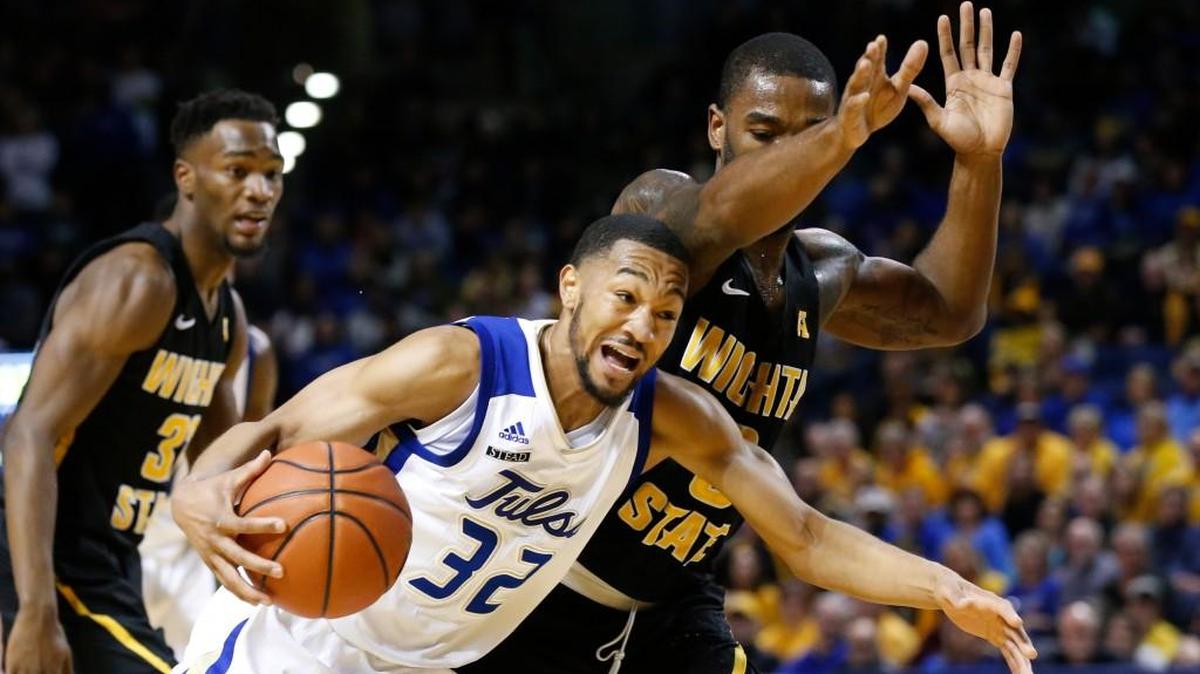 Tulsa guard Corey Henderson Jr.drives past Wichita State forward Rashard Kelly on Saturday in Tulsa.