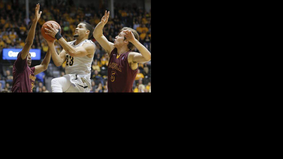 
Wichita State guard Fred VanVleet goes to the basket against Loyola guard Earl Peterson, left, and guard Joe Crisman during the first half on Wednesday night at Koch Arena. VanVleet scored 16 of WSU’s 29 first-half points.
